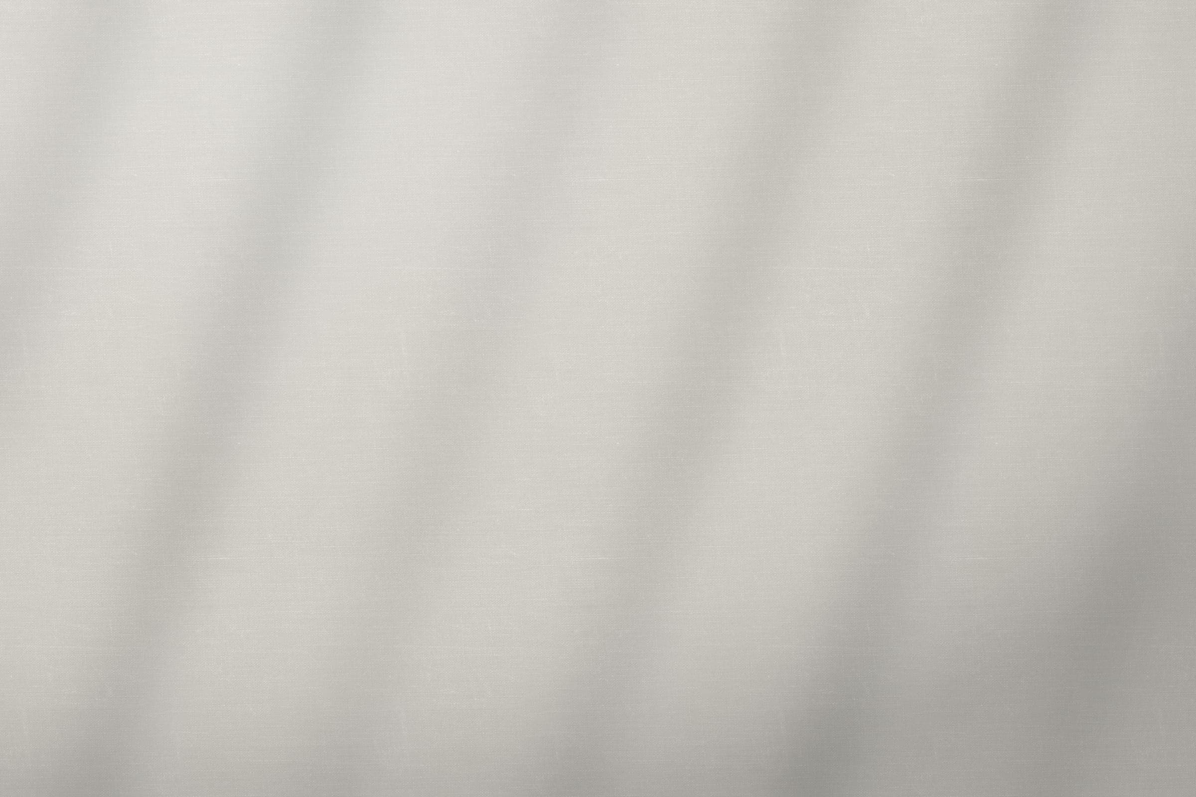 Warm white cotton canvas filling the frame, rippling softly in the light